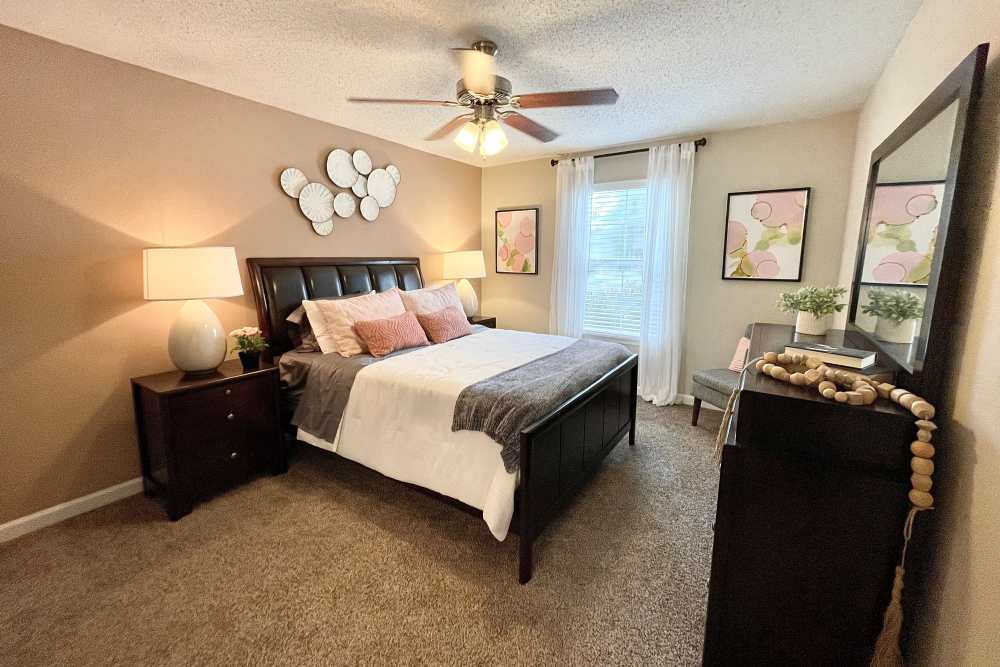 Bedroom with ceiling fan at The Abbey at Riverchase in Hoover, Alabama