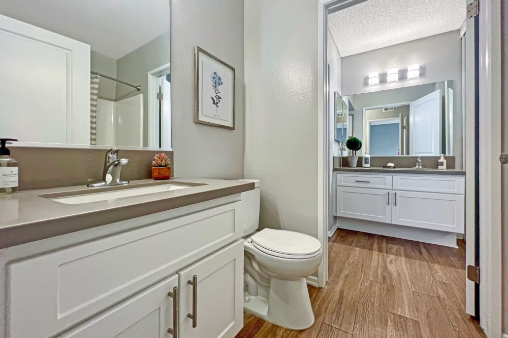 Wood-style flooring in a bathroom at Portofino Townhomes in Wilmington, California