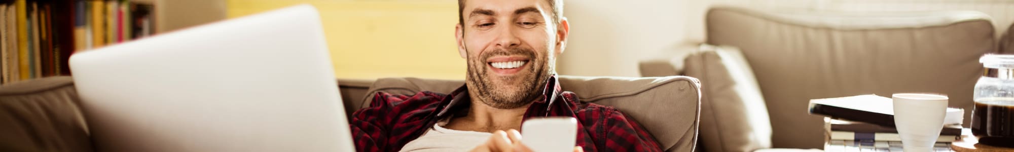 Resident sitting on the sofa at Springwood Gardens apartments