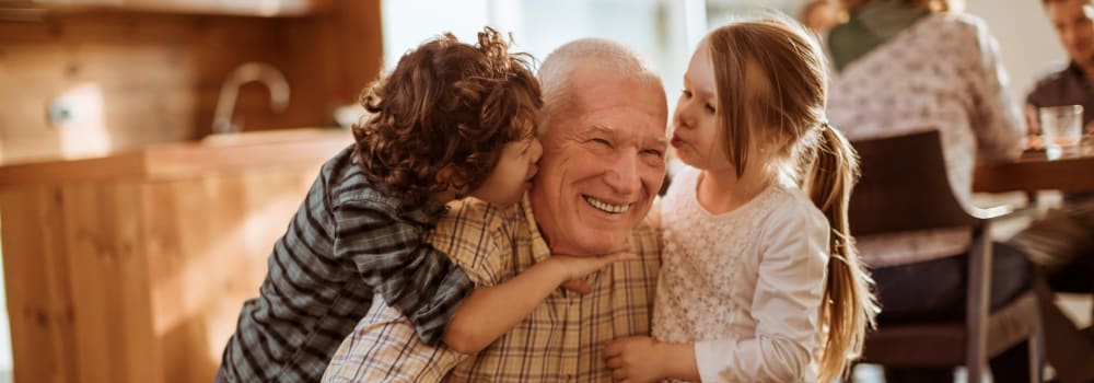 A resident doting on his grandchildren at a Stoney Brook community. 