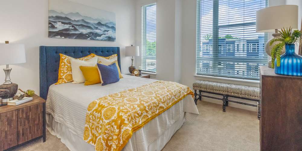 Cozy bedroom with a large bed and windows at The Griff in Charlotte, North Carolina