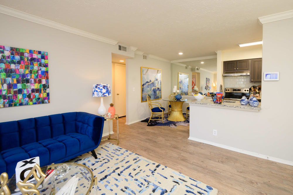 Living room with a view of the kitchen over the breakfast bar in a model apartment at The Hamilton in Hendersonville, Tennessee