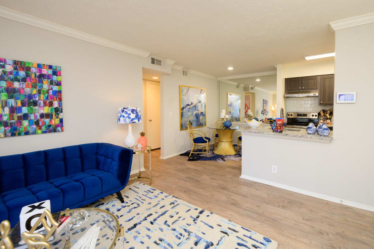 Open-concept living area with hardwood floors and modern furnishings in a model apartment at The Hamilton in Hendersonville, Tennessee
