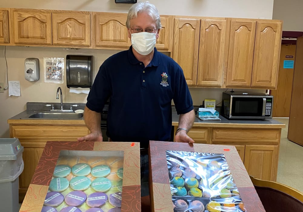 Staff member with baked good for resident at Montello Care Center in Montello, Wisconsin