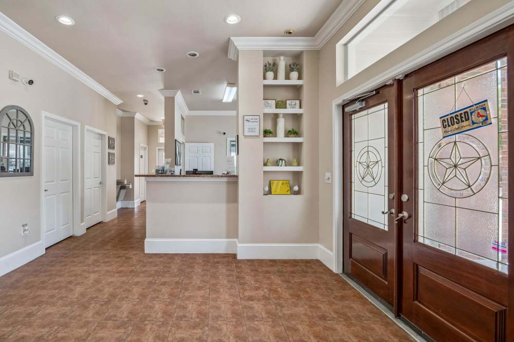 Community apartment entryway with built-in shelving at Atascocita Pines in Humble, Texas