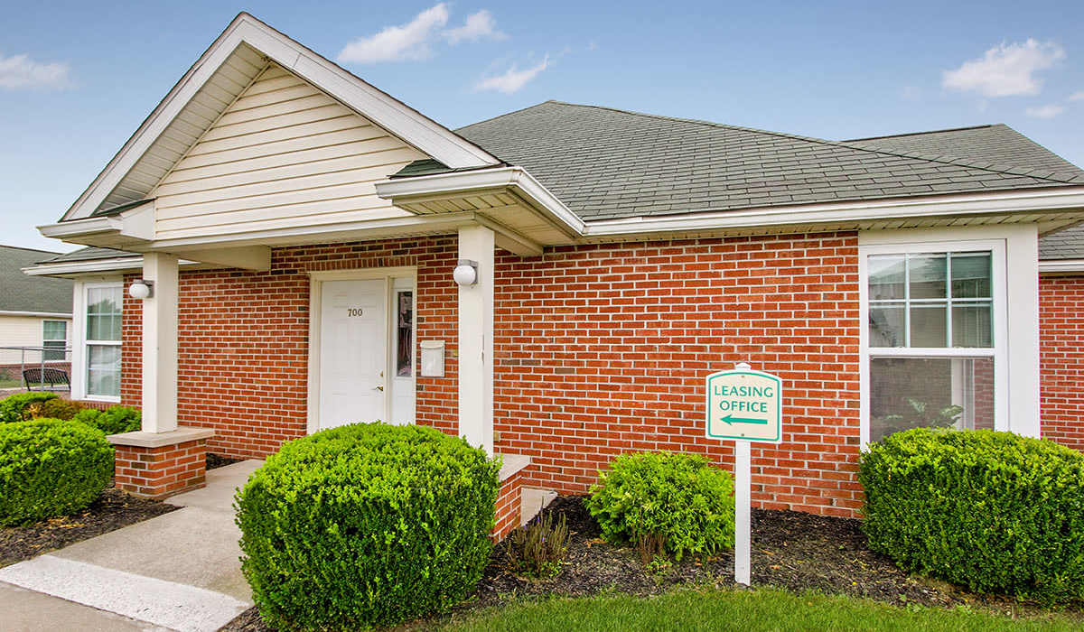 Leasing office sign with brick building at Wellington Place in Ottawa, Ohio