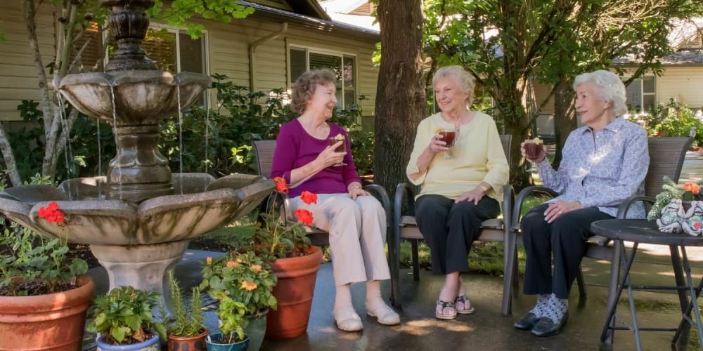 Residents relaxing near a fountain sipping ice tea at The Springs at Wilsonville in Wilsonville, Oregon