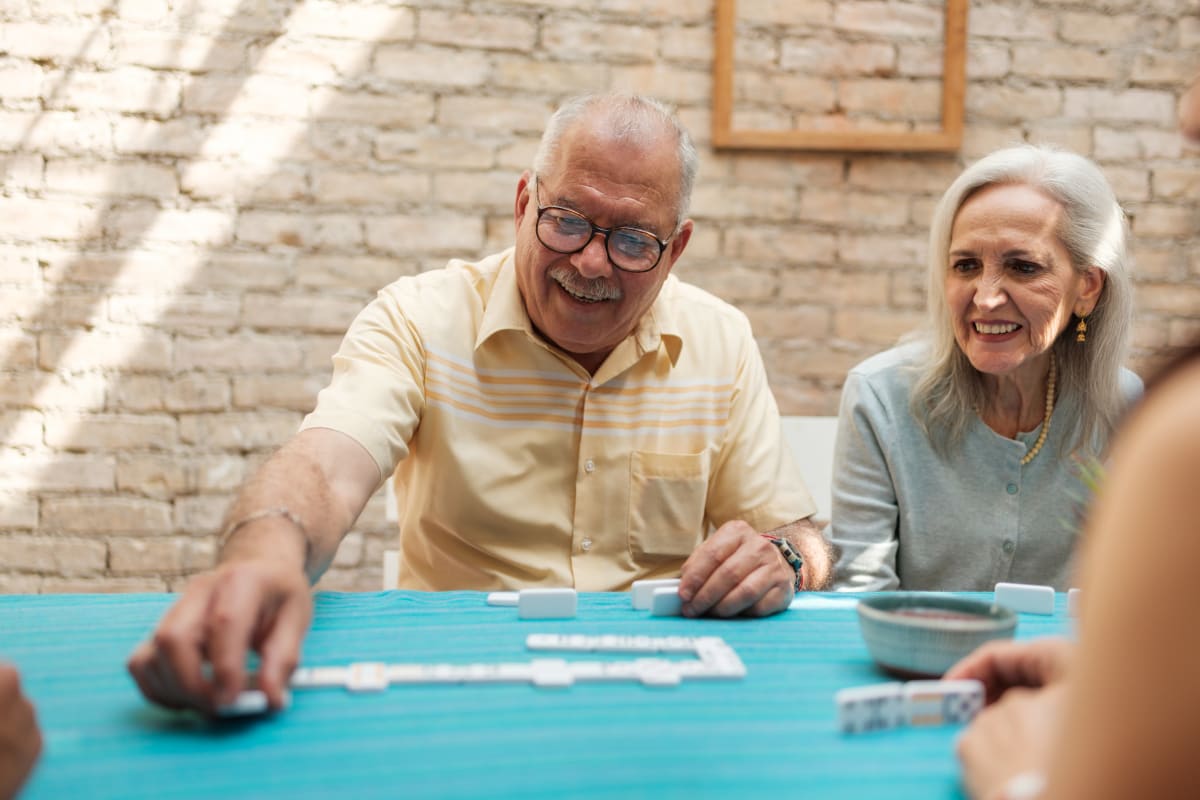 Residents enjoying a game of dominoes at a Meridian Senior Living community