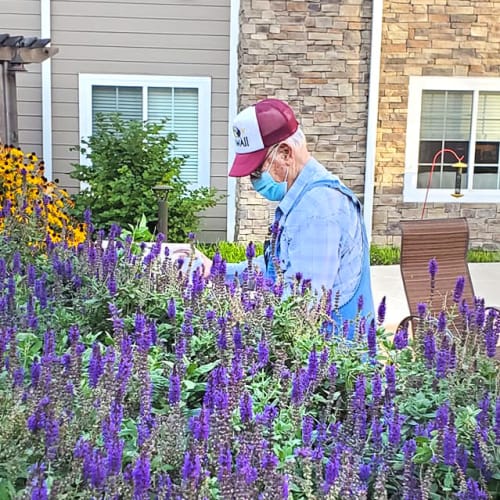 A happy resident gardening at The Oxford Grand Assisted Living & Memory Care in Kansas City, Missouri