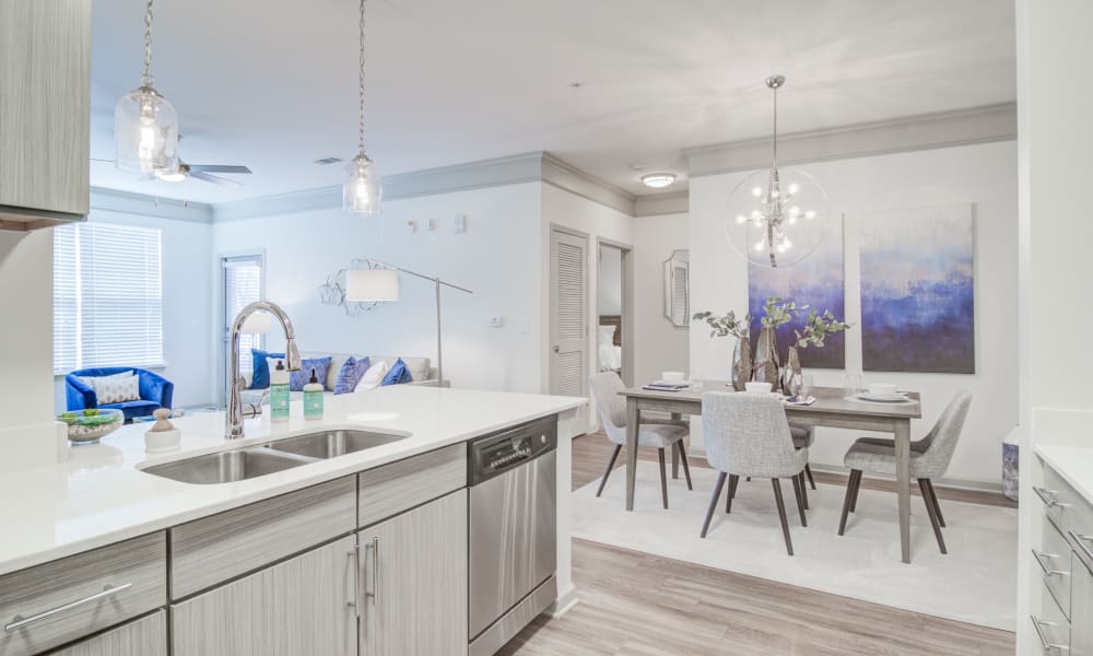 A model kitchen and adjacent dining room in an apartment at Bradley Park Apartments in Cumming, Georgia