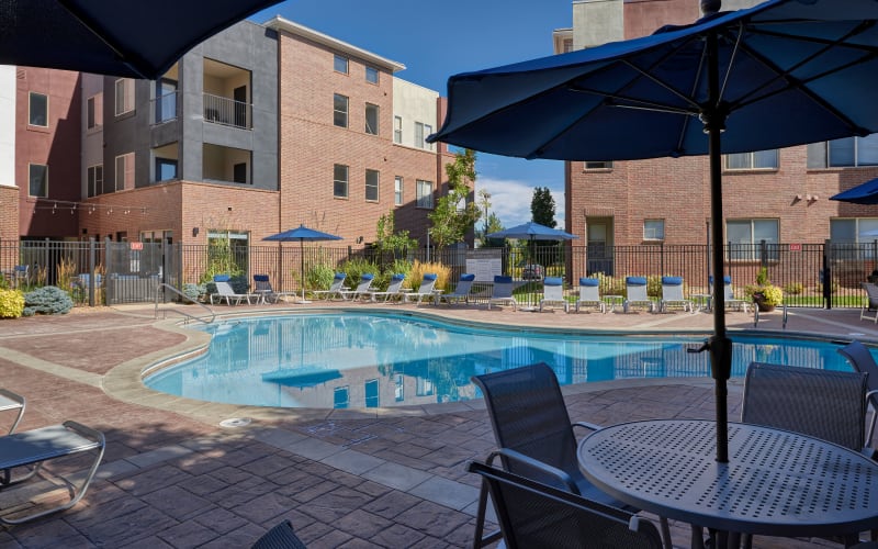Covered seating near the swimming pool at The Rail at Inverness in Englewood, Colorado