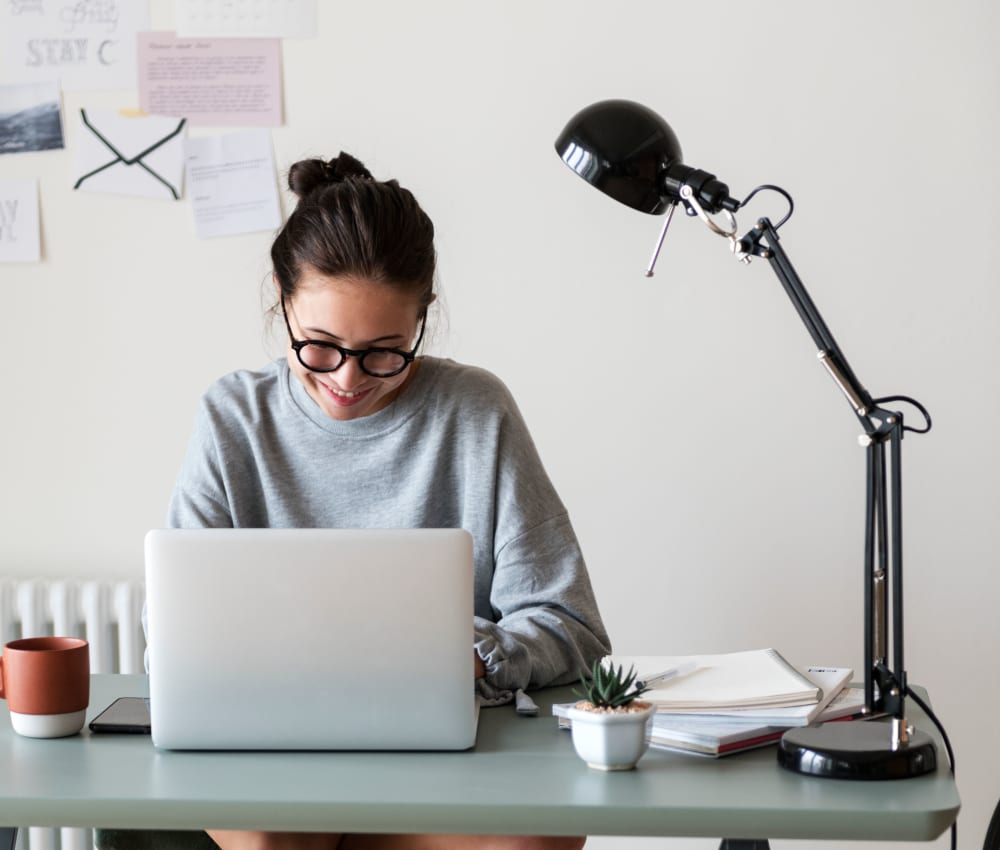 Resident student doing some homework on her laptop at Harbor Point Apartments in Mill Valley, California