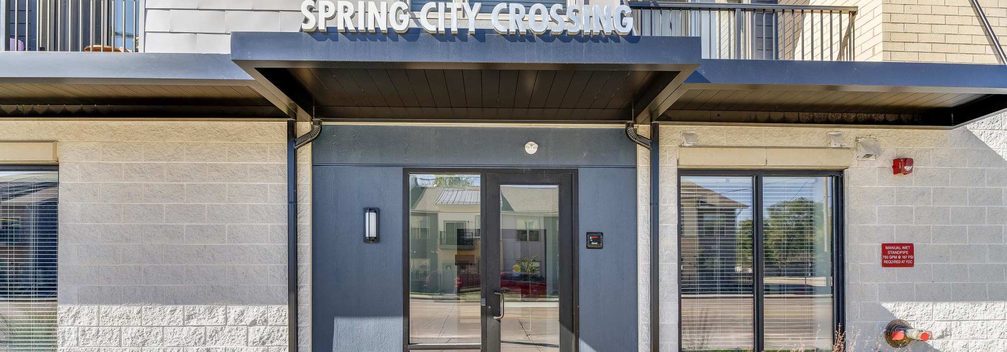 Entrance of apartment with signage at Spring City Crossing in Waukesha, Wisconsin