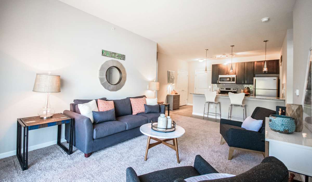 Spacious living room with couch and plenty of natural light at Mirada Apartments in Lewis Center, Ohio