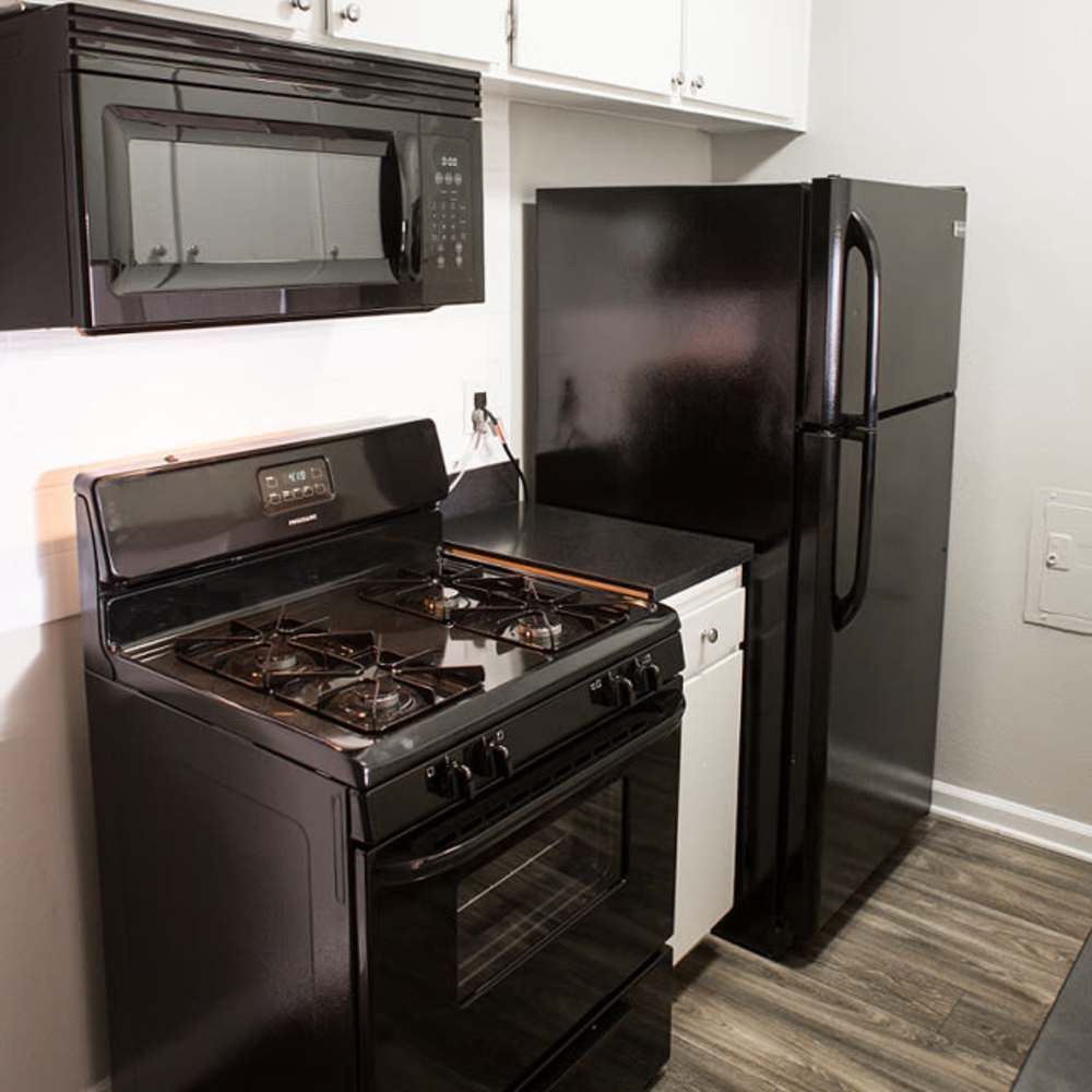 Modern kitchen with black appliances at Park Terrace in Reseda, California,