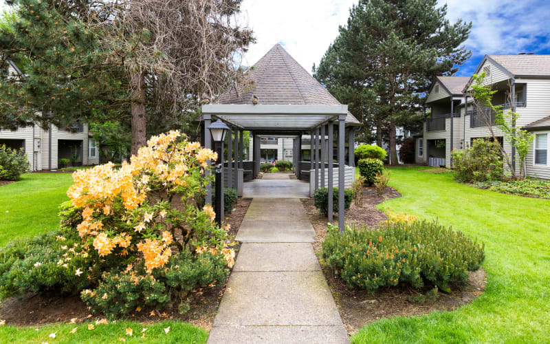 Lush landscaping around a gazebo at Meadows at Cascade Park Apartments in Vancouver, Washington