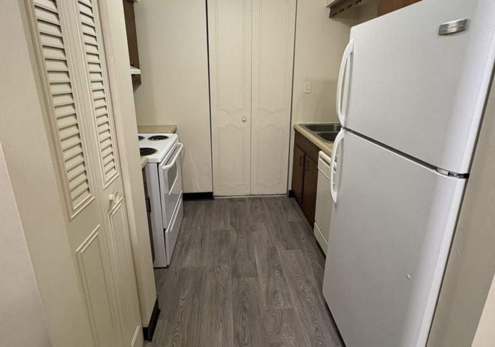 Kitchen with white appliances at Mount Vernon Arms Apartments in Merrillville,Indiana