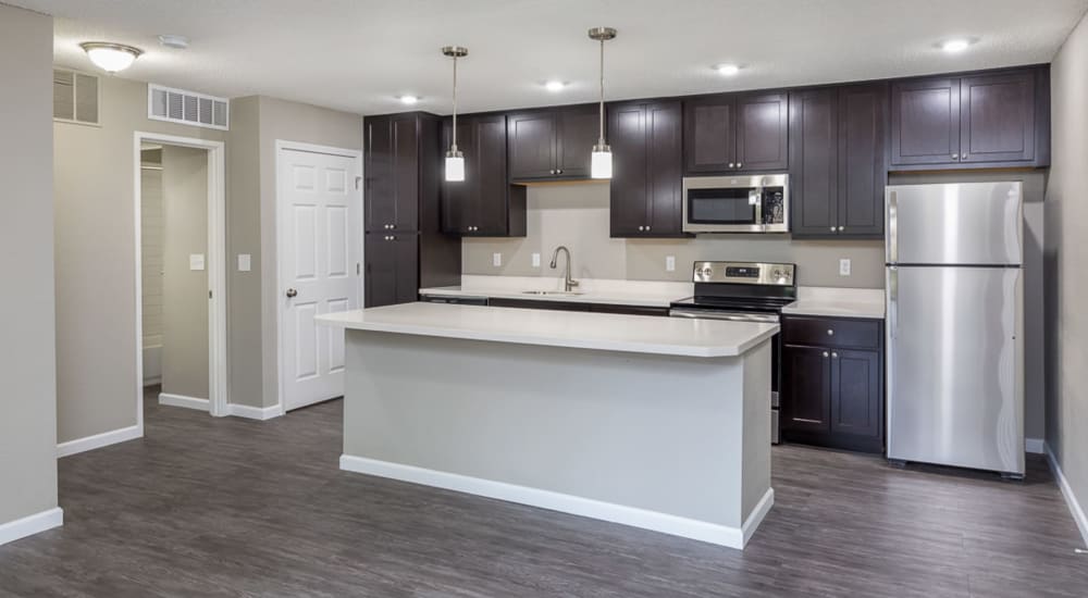 Immaculate kitchen with breakfast bar and hardwood floors at Springhill Apartments in Overland Park, Kansas