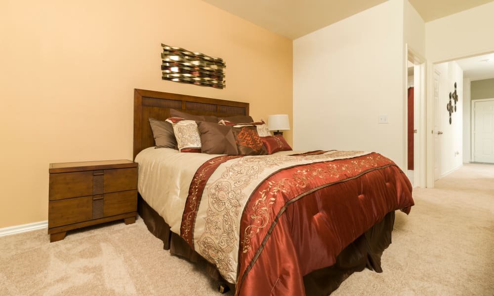 Bedroom , wall-to-wall carpeting in a model home at Villa du Lac Apartment Homes in Slidell, Louisiana