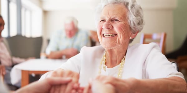 Resident smiling ear to ear in the dining room at Edgerton Care Center in Edgerton, Wisconsin