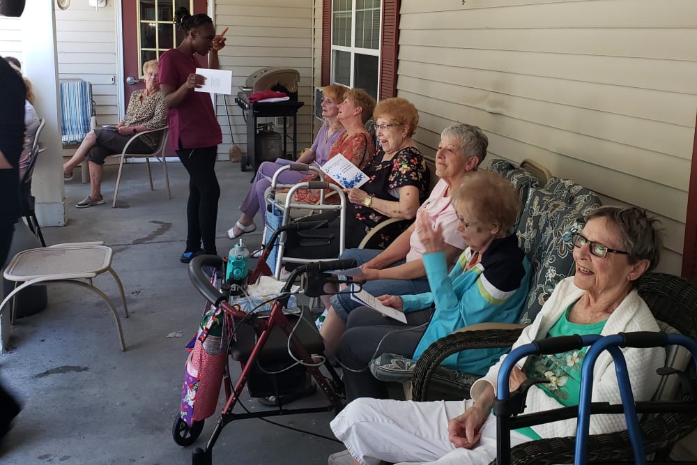 Residents sit on the porch and enjoy time with each other at Landings of Blaine in Blaine, Minnesota