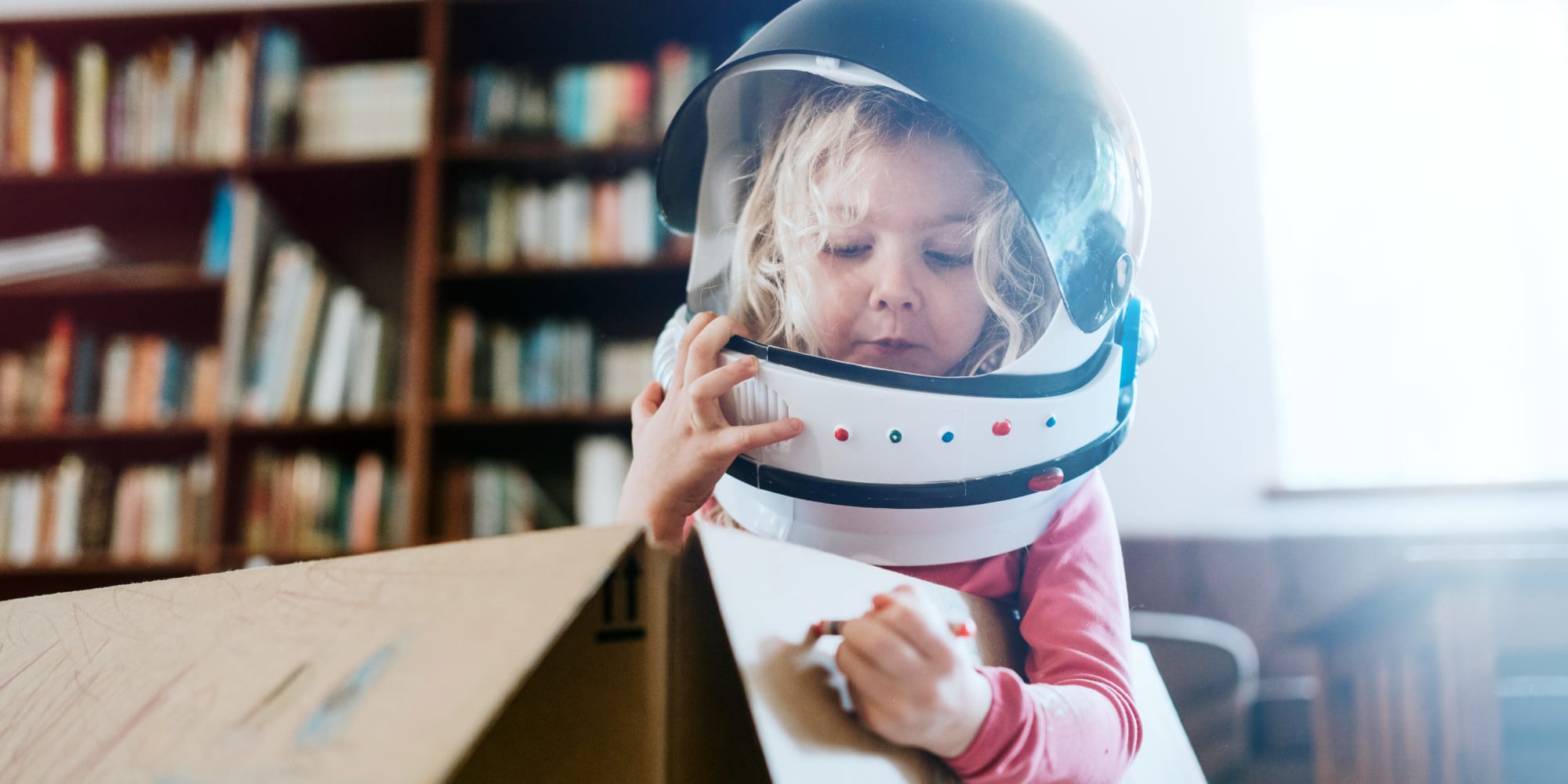 Kid playing with astronaut costume and having fun with boxes at A3 Storage Centers in Wolfforth, Texas