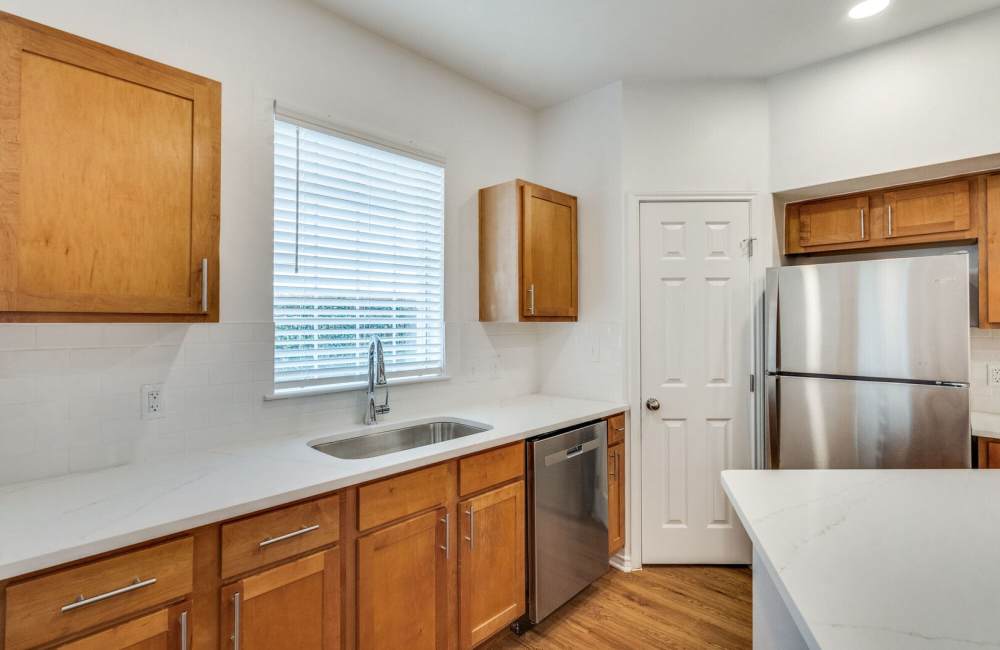Modern kitchen with granite countertops at Spicewood Crossing in Carrollton, Texas