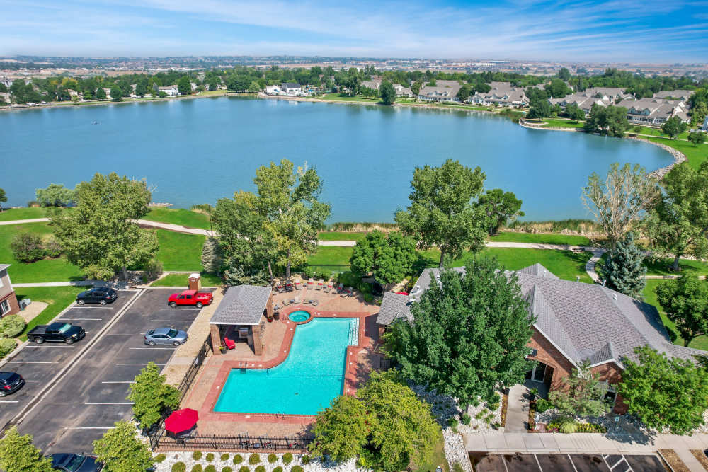 Aerial view of the apartments with lake at Promenade at Hunter's Glen Apartments in Thornton, Colorado