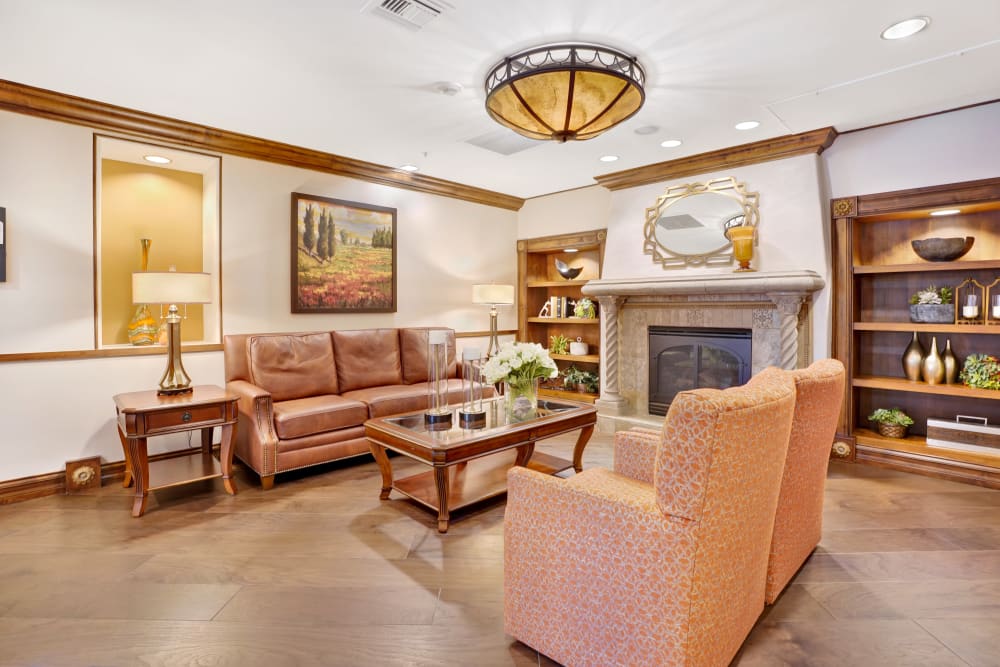 Community cozy seating area with couch, chairs, and fireplace at Tuscany at McCormick Ranch in Scottsdale, Arizona