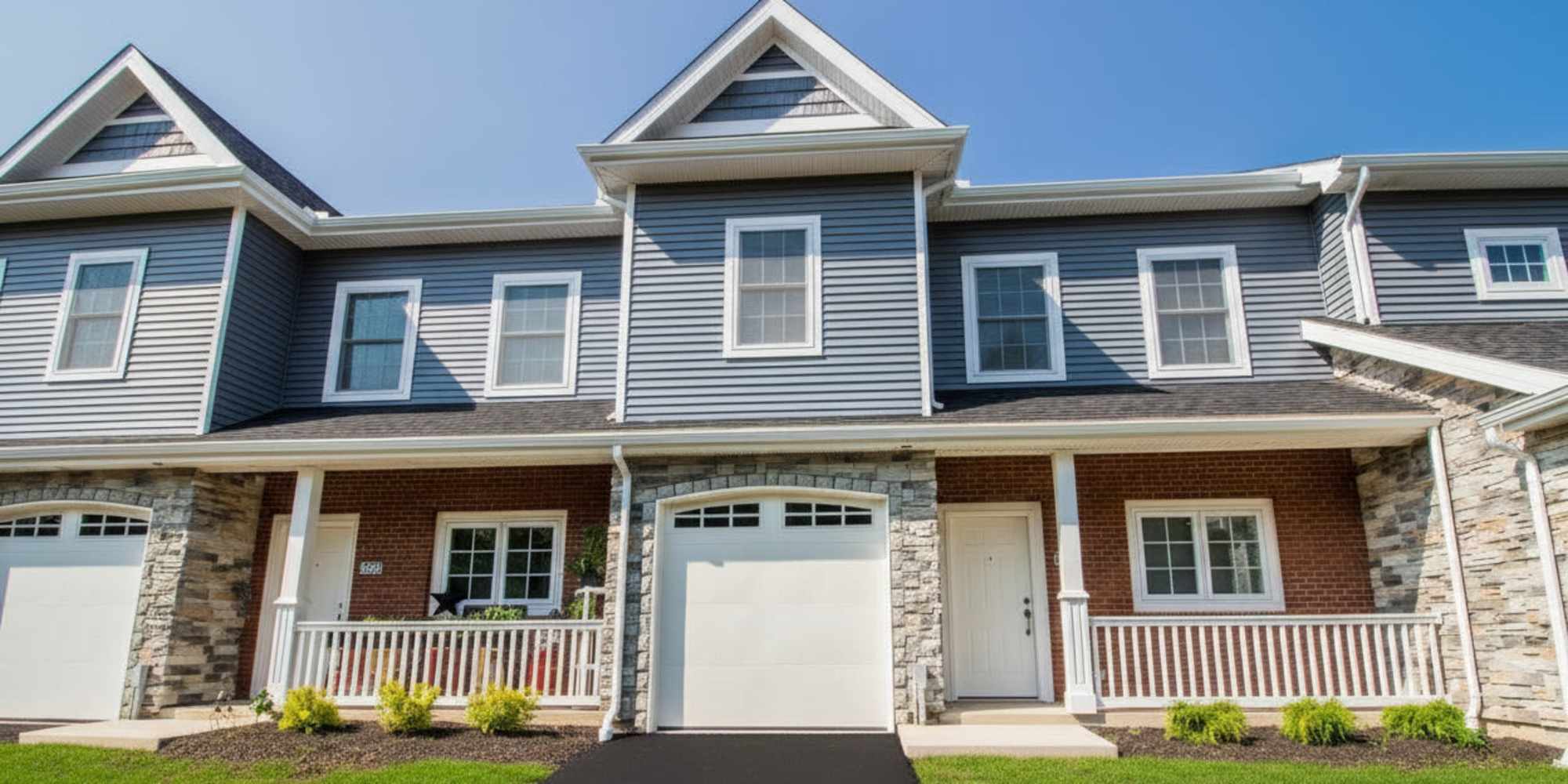 Exterior view of the front of the units with garages at Waterford Townhomes in Clarence Center, New York