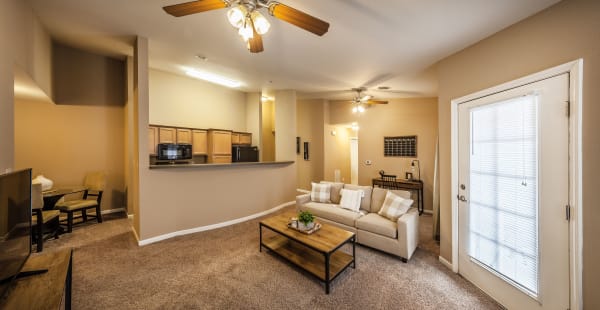 Spacious living room and dining area with pass-through to kitchen at Cobblestone Crossings in Terre Haute, Indiana