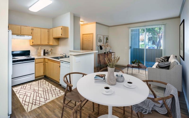 A decorated dining room and kitchen at Natomas Park Apartments in Sacramento, California