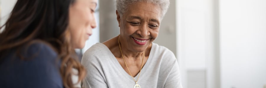 Resident sitting and talking with a caretaker at Geneva Lake Manor in Lake Geneva, Wisconsin