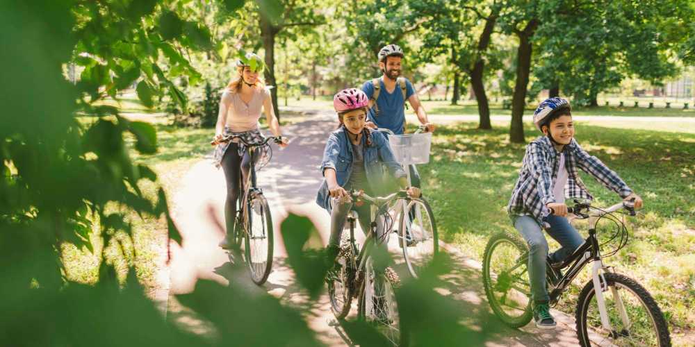 Family cycling together near The View at Wash Park in Denver, Colorado