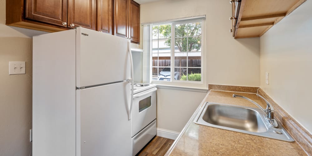 Kitchen with white appliances at Mountain View Apartments in Concord, California