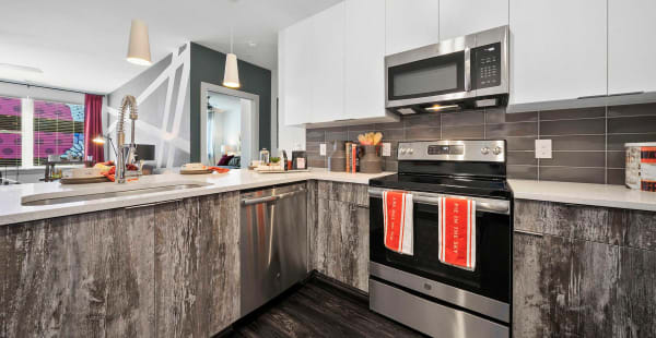 Gourmet kitchen with granite counters and contemporary cabinetry at EDGE on the Beltline in Atlanta, Georgia