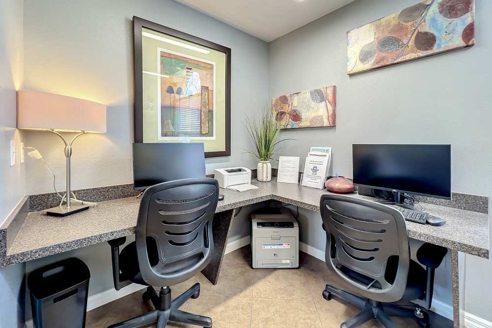 Computers with desk and chairs inside of a leasing office at Huntington Reserve in Sanford, Florida
