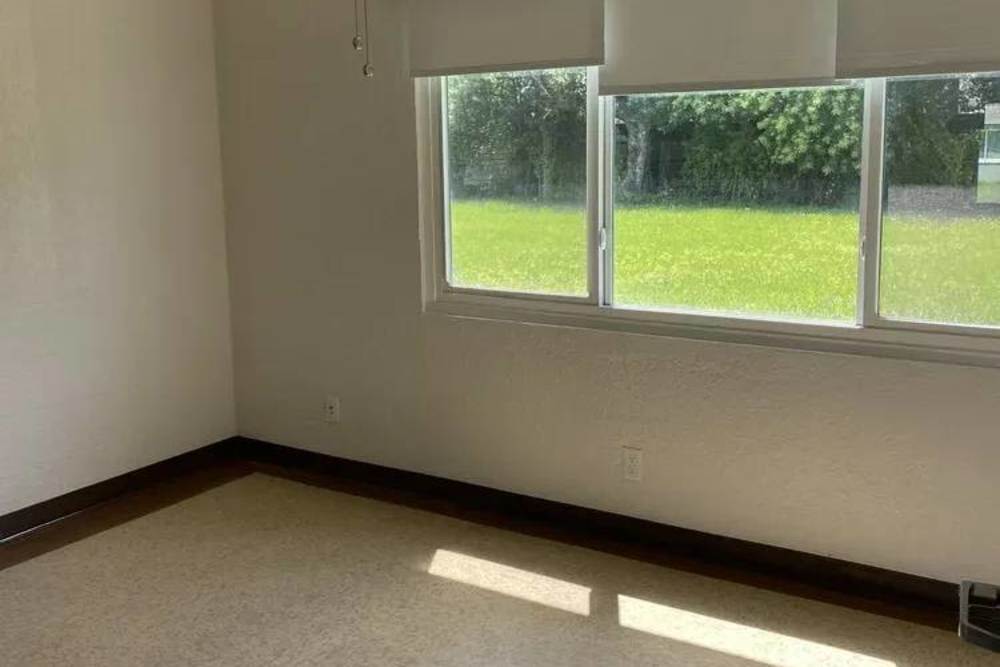 Bedroom with large window at Pineda Village in Cocoa, Florida