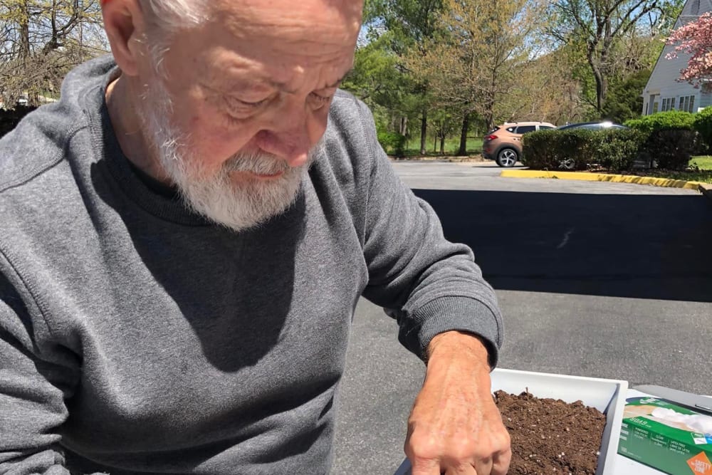 A resident gardening at Lavender Hills Front Royal Campus in Front Royal, Virginia