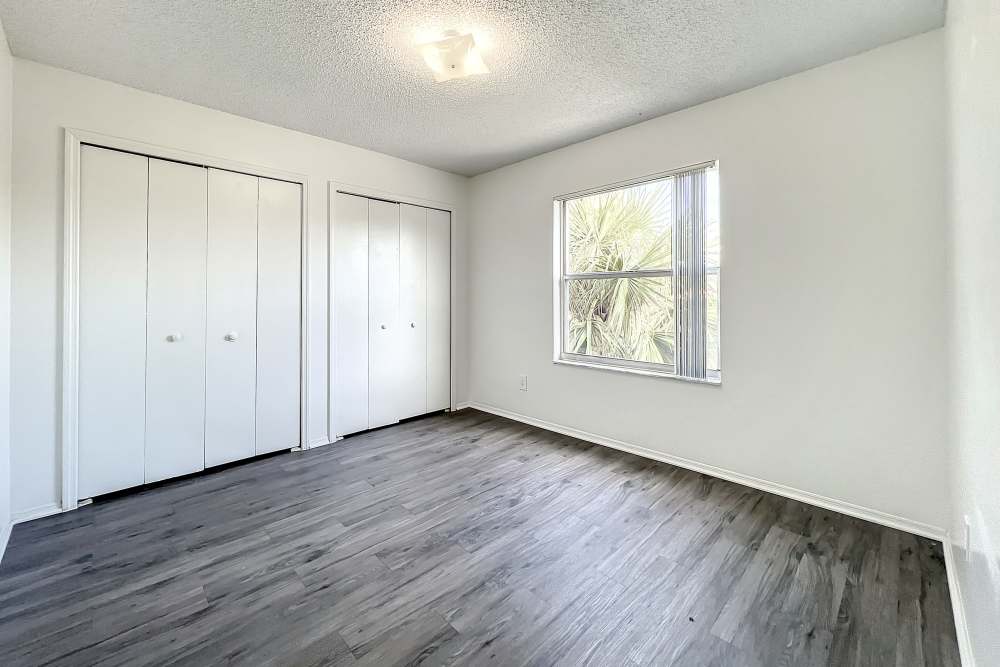 Bedroom with closets and a window at Huntington Reserve in Sanford, Florida