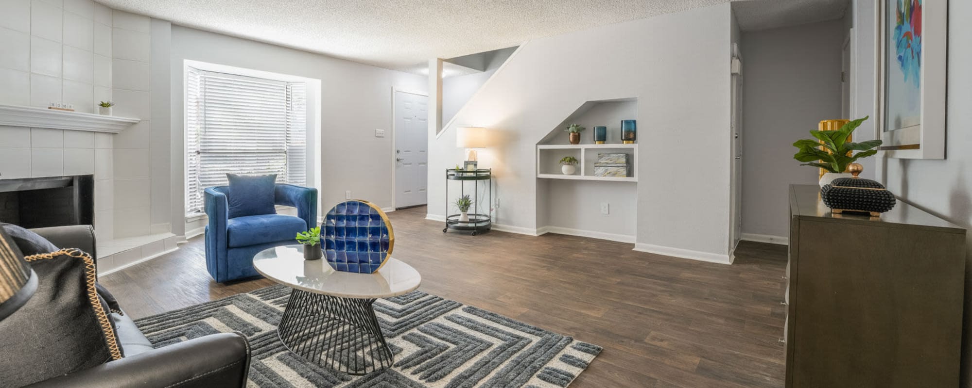 Residents living space with wood-style flooring at Lakebridge Townhomes in Houston, Texas