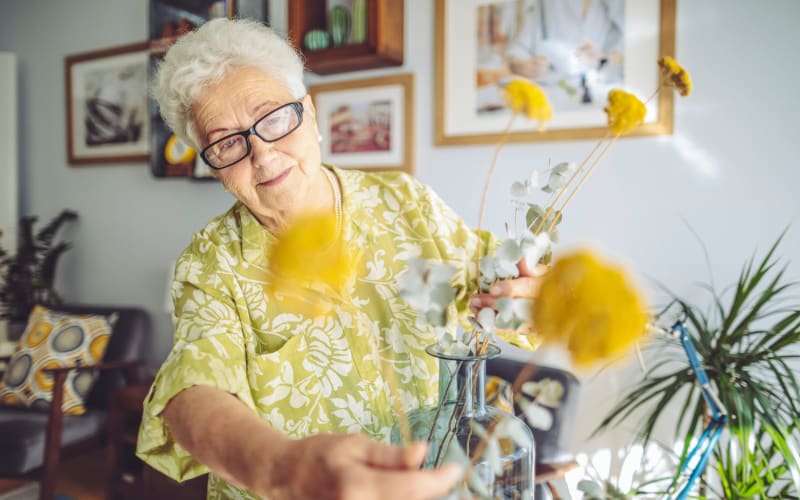 Resident with flowers at The Blake at Biloxi in Biloxi, Mississippi