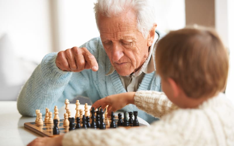 A resident playing a chess with his kid at Grand Villa of Clearwater in Clearwater, Florida