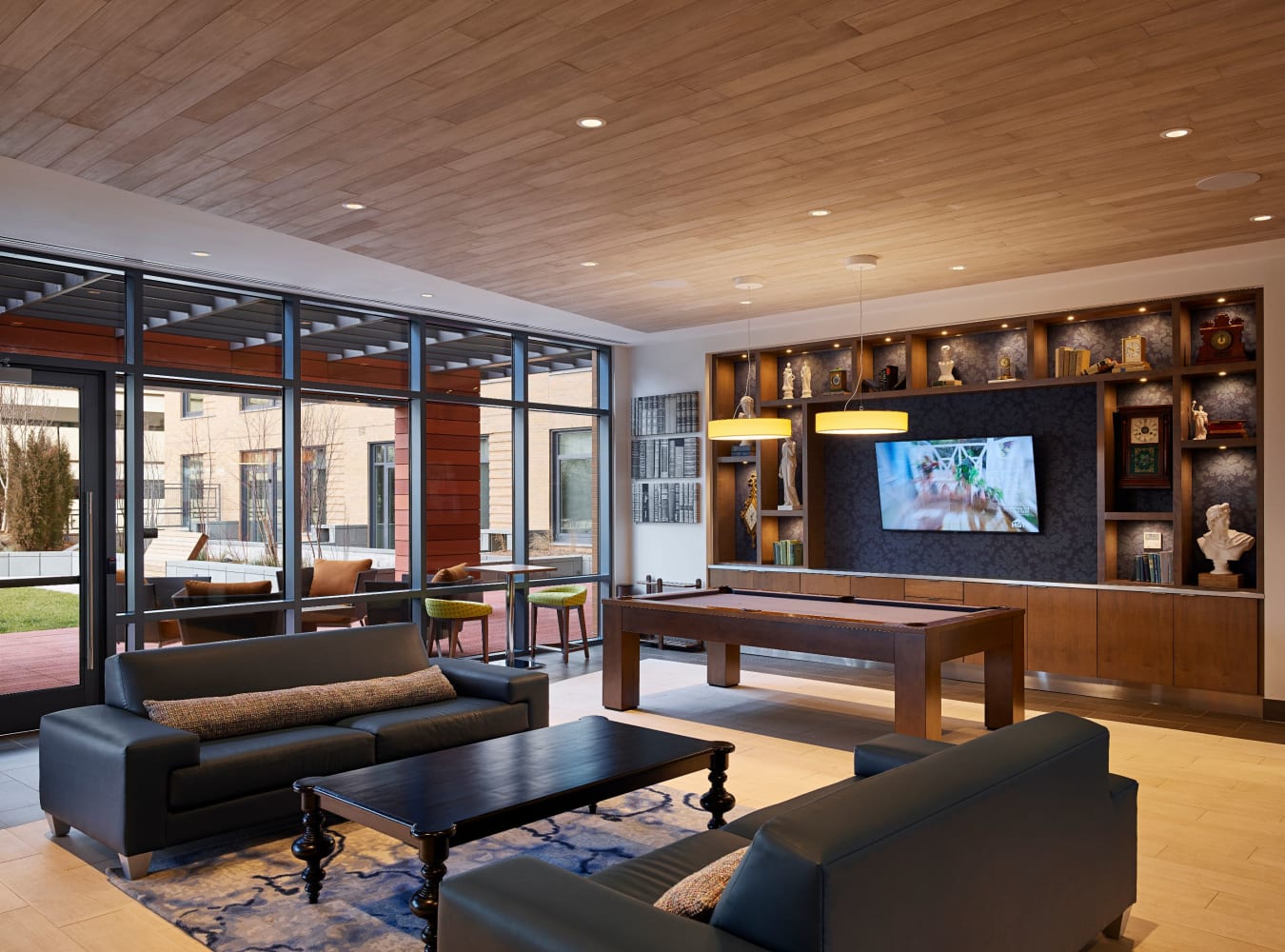 Clubhouse with comfortable seating and a pool table at Solaire 8250 Georgia in Silver Spring, Maryland