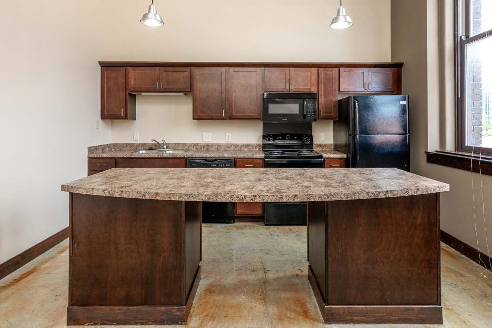 Kitchen island with countertop and cabinets at Rumely Lofts in Des Moines, Iowa