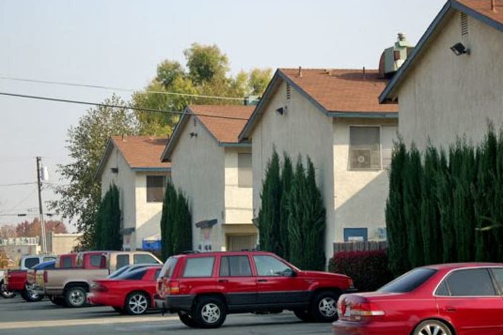 Parking and units at El Potrero Apartments in Bakersfield, California