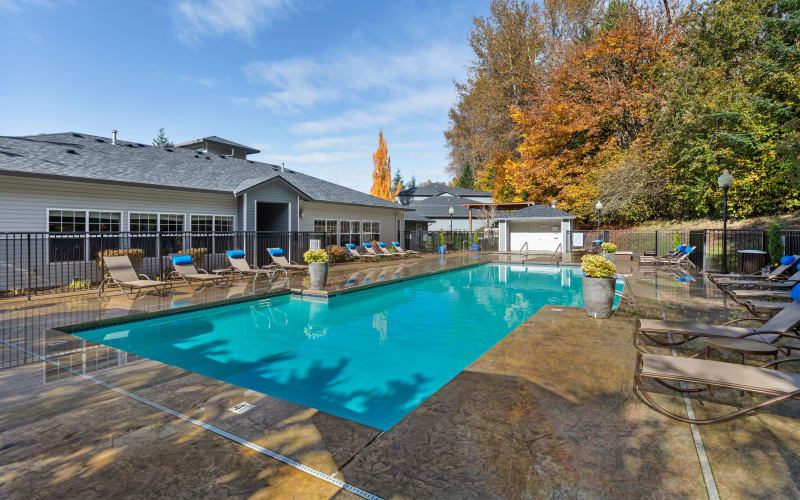 Large bright blue swimming pool at Pebble Cove Apartments in Renton, Washington