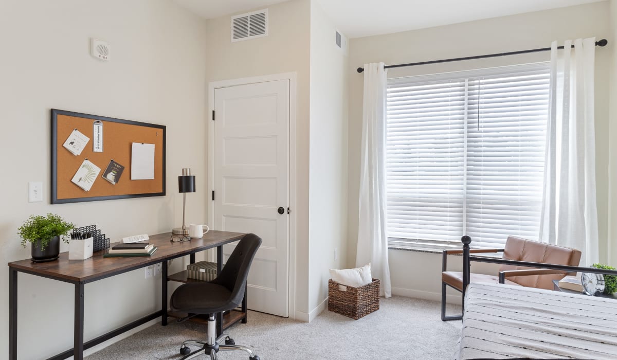 Large room with desk at Arasan Apartments in Shakopee, Minnesota