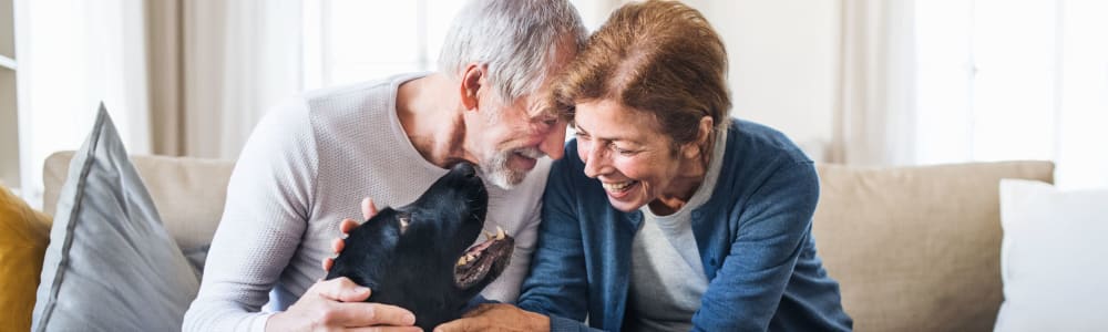 Dog visitor with senior and caregiver at Villas At Maple Ridge in Spooner, Wisconsin