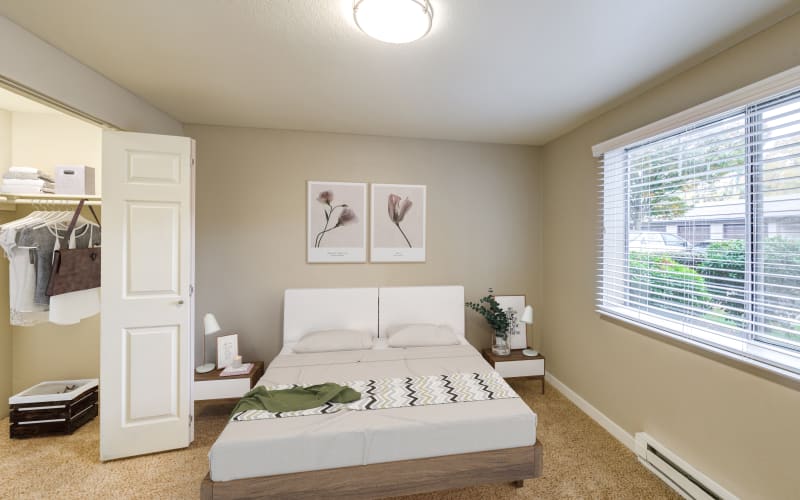 Spacious master bedroom with plush carpeting at Olin Fields Apartments in Everett, Washington